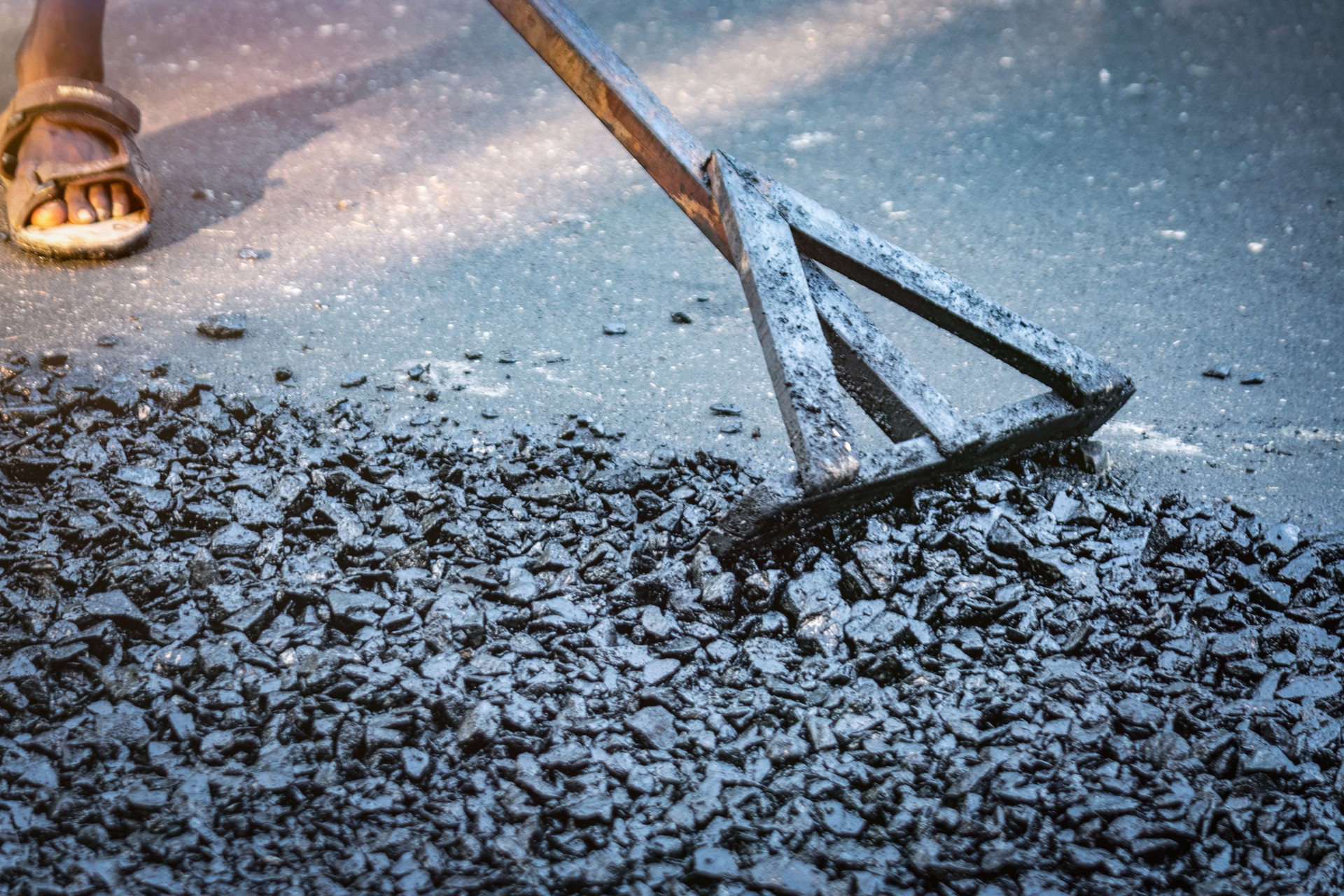 Construction Workers Repaving Roads with Fresh Asphalt